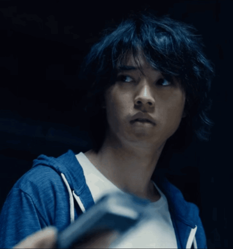 A Close Up Of A Person 'S Face With A Blue Hoodie GIF