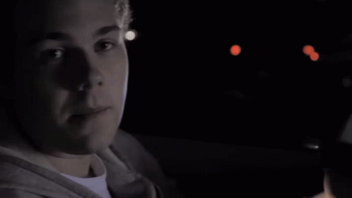 A Close Up Of A Person 'S Face With A Blue Light Behind Them GIF