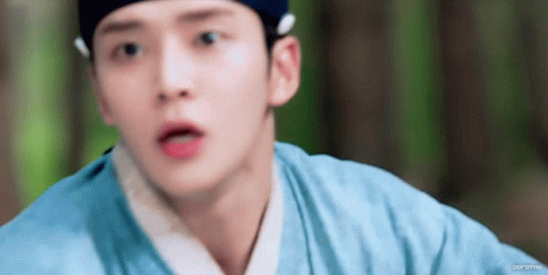 A Close Up Of A Person 'S Face With A Blue Shirt On GIF