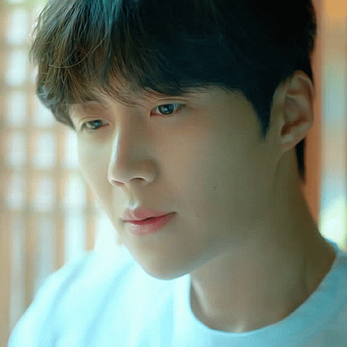 A Close Up Of A Person 'S Face With A Blue Shirt On GIF