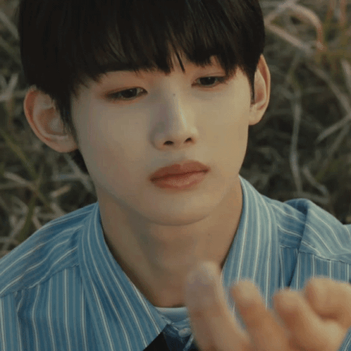 A Close Up Of A Person 'S Face With A Blue Shirt On GIF