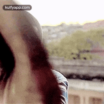 A Close Up Of A Person 'S Face With A Blurred Background . GIF