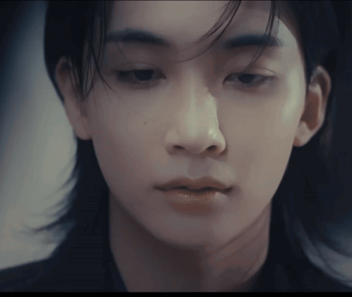 A Close Up Of A Person 'S Face With A Blurred Background GIF