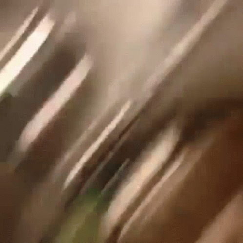 A Close Up Of A Person 'S Face With A Blurry Background GIF