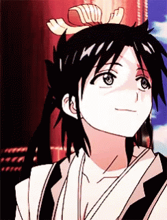 A Close Up Of A Person 'S Face With A Bow In Their Hair . GIF