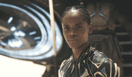 A Close Up Of A Person 'S Face With A Clock Behind Them GIF