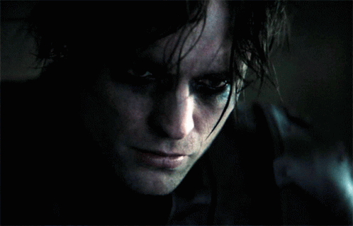 A Close Up Of A Person 'S Face With A Dark Background GIF