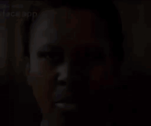 A Close Up Of A Person 'S Face With A Face App Written On It . GIF