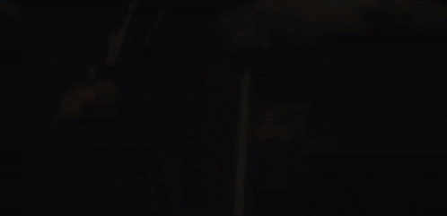 A Close Up Of A Person 'S Face With A Fire Behind Them GIF