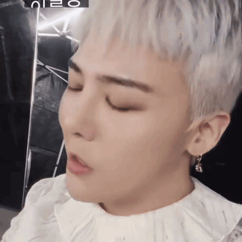 A Close Up Of A Person 'S Face With A Foreign Language Written On The Bottom GIF