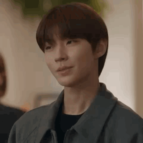 A Close Up Of A Person 'S Face With A Gray Jacket On . GIF