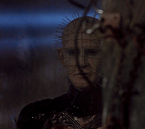 a close up of a person 's face with a grid of spikes on it