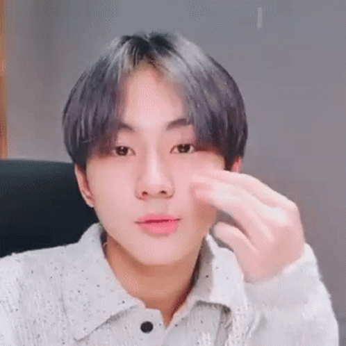 A Close Up Of A Person 'S Face With A Hand On It . GIF