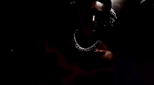 A Close Up Of A Person 'S Face With A Knife In Their Mouth . GIF