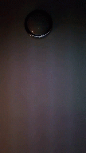 A Close Up Of A Person 'S Face With A Light Behind It GIF