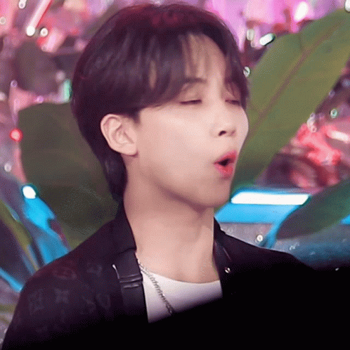 A Close Up Of A Person 'S Face With A Louis Vuitton Jacket On GIF