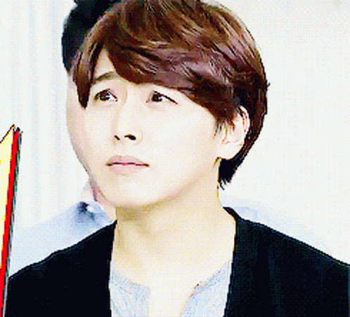 A Close Up Of A Person 'S Face With A Man In The Background GIF