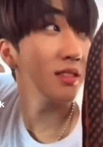 A Close Up Of A Person 'S Face With A Necklace On . GIF