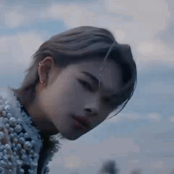 A Close Up Of A Person 'S Face With A Piercing In Their Ear . GIF