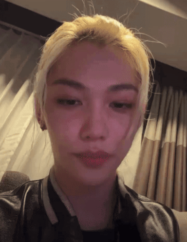 A Close Up Of A Person 'S Face With A Pink Background GIF