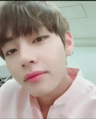 A Close Up Of A Person 'S Face With A Pink Shirt On And A Pink Lip . GIF