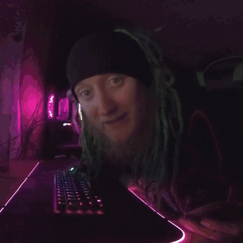 A Close Up Of A Person 'S Face With A Purple Background . GIF
