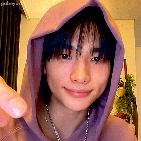 A Close Up Of A Person 'S Face With A Purple Hoodie On GIF
