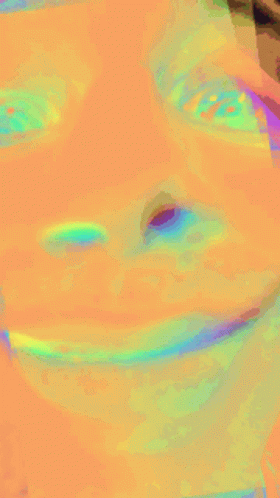 A Close Up Of A Person 'S Face With A Rainbow Of Colors GIF