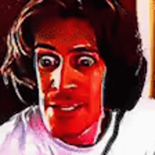 A Close Up Of A Person 'S Face With A Red Background And Headphones On . GIF