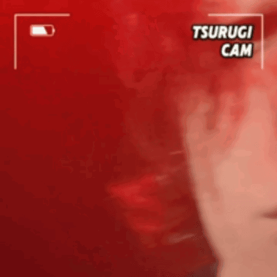 A Close Up Of A Person 'S Face With A Red Background And The Words Tsurugi Cam On It . GIF