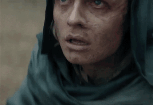 A Close Up Of A Person 'S Face With A Scarf Around Their Head GIF