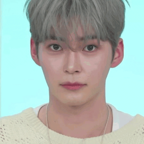 A Close Up Of A Person 'S Face With A Smiley Face Behind Them GIF