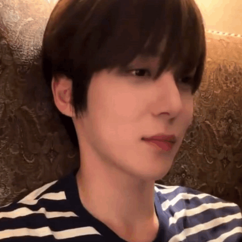 A Close Up Of A Person 'S Face With A Striped Shirt On GIF