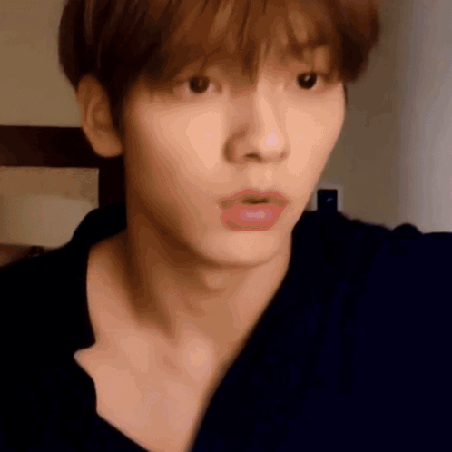 A Close Up Of A Person 'S Face With A Surprised Look On Their Face GIF