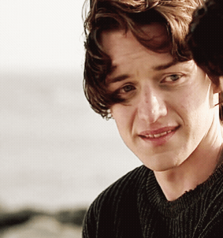 A Close Up Of A Person 'S Face With A Sweater On GIF