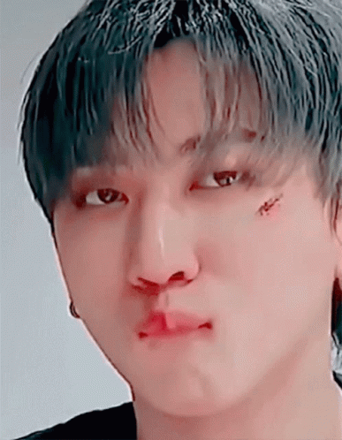 A Close Up Of A Person 'S Face With A Tattoo On Their Face GIF