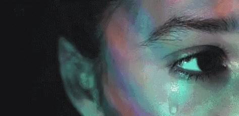A Close Up Of A Person 'S Face With A Tear Coming Out Of It . GIF
