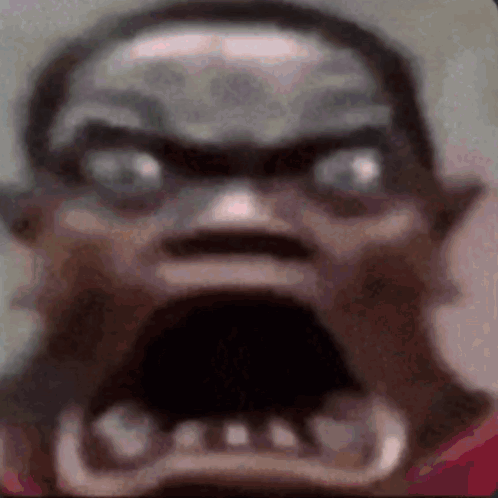 A Close Up Of A Person 'S Face With A Very Angry Look On It . GIF