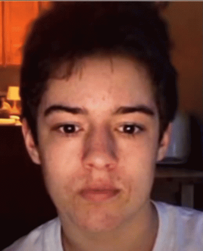 A Close Up Of A Person 'S Face With A White Shirt GIF