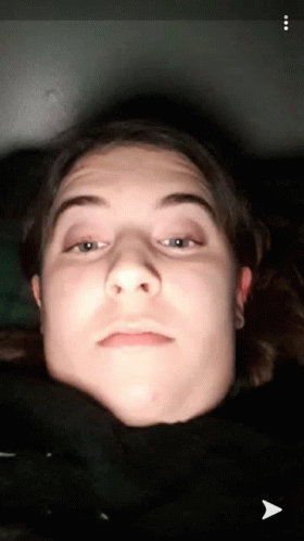A Close Up Of A Person 'S Face With An Arrow Pointing To The Bottom Left GIF