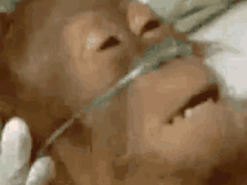 A Close Up Of A Person 'S Face With An Oxygen Mask GIF