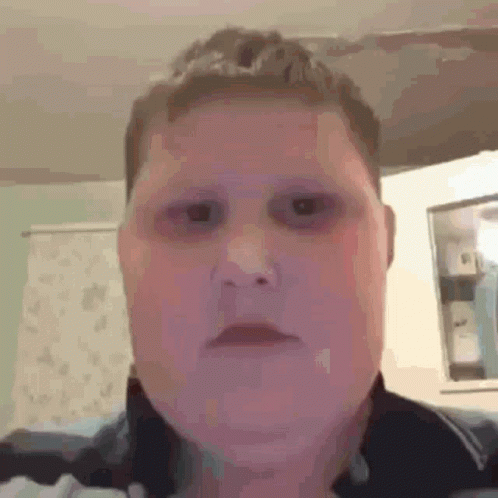A Close Up Of A Person 'S Face With Black Eyes And A Purple Background . GIF