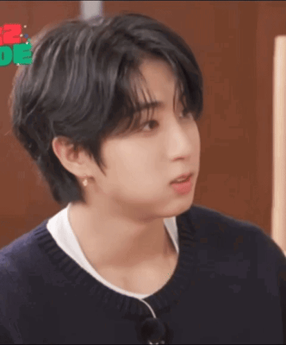 A Close Up Of A Person 'S Face With Black Hair And A White Shirt . GIF