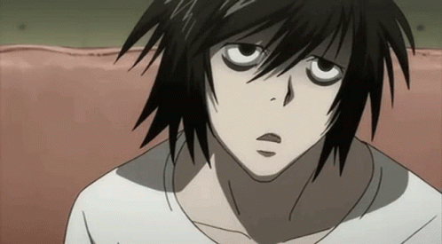 A Close Up Of A Person 'S Face With Black Hair And A White Shirt . GIF