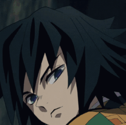 A Close Up Of A Person 'S Face With Black Hair And Green Eyes GIF