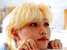 A Close Up Of A Person 'S Face With Blonde Hair And Red Lips . GIF