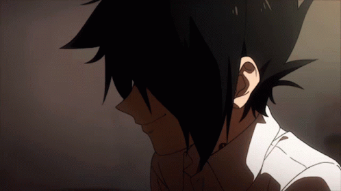 A Close Up Of A Person 'S Face With Dark Hair And A White Shirt GIF