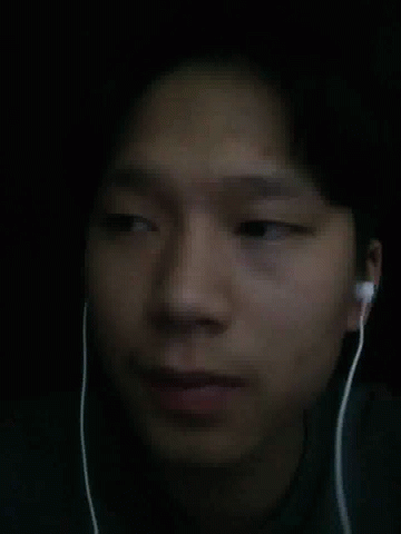 A Close Up Of A Person 'S Face With Ear Buds On GIF
