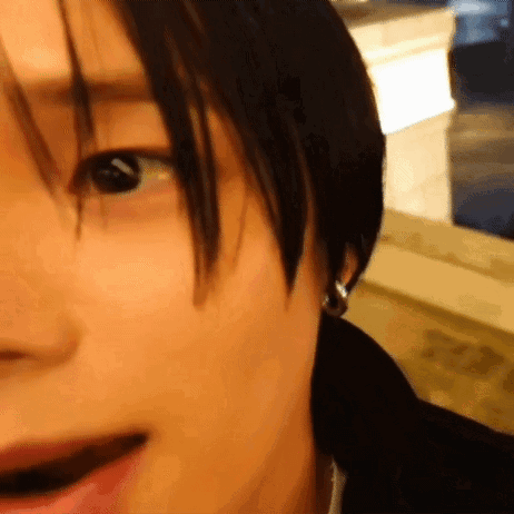 A Close Up Of A Person 'S Face With Earrings On GIF