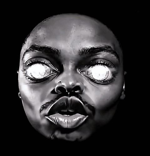 A Close Up Of A Person 'S Face With Glowing Eyes GIF